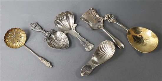 Three various 19th century silver caddy spoons, a modern parcel gilt spoon by Michael Allen Bolton and tow other spoons.